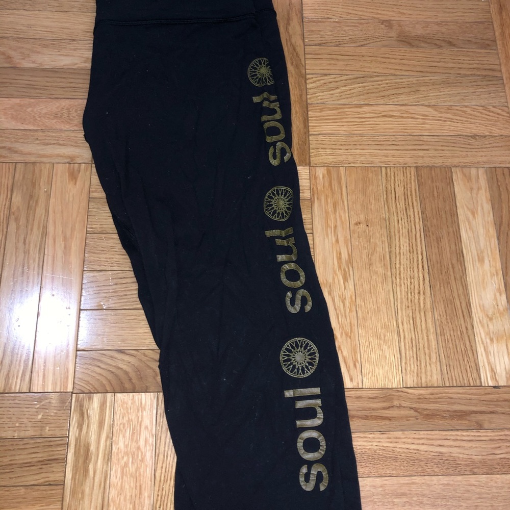 Black lululemon Soulcycle crop with gold writing.